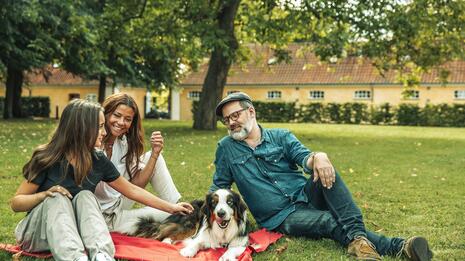 Familie sitter sammen i en park