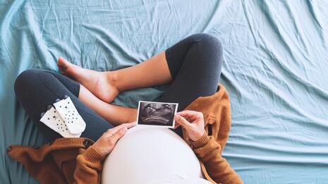 Gravid kvinne som holder et ultralydbilde