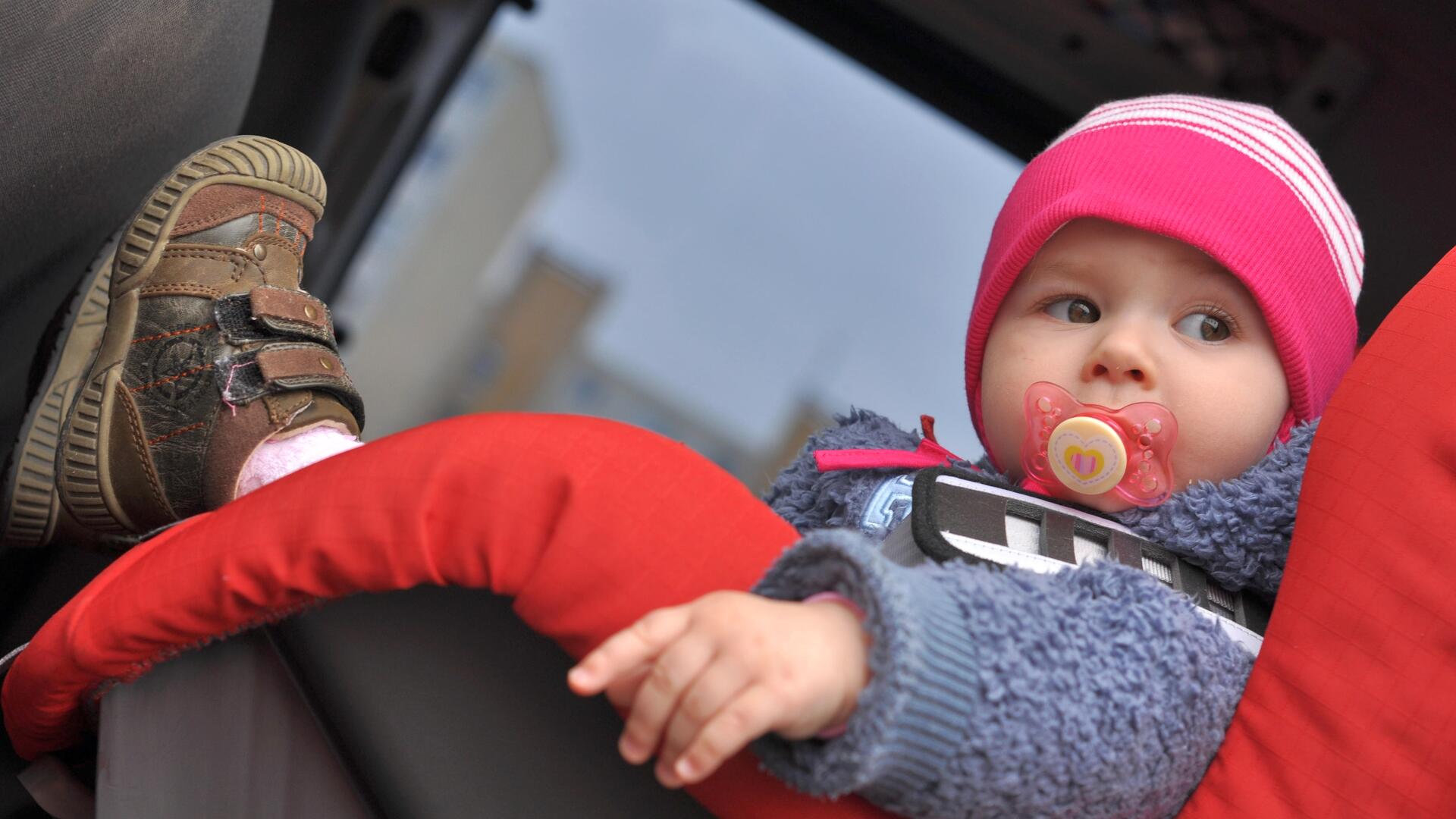 Baby i barnesete med sikkerhetsbelte på i bil