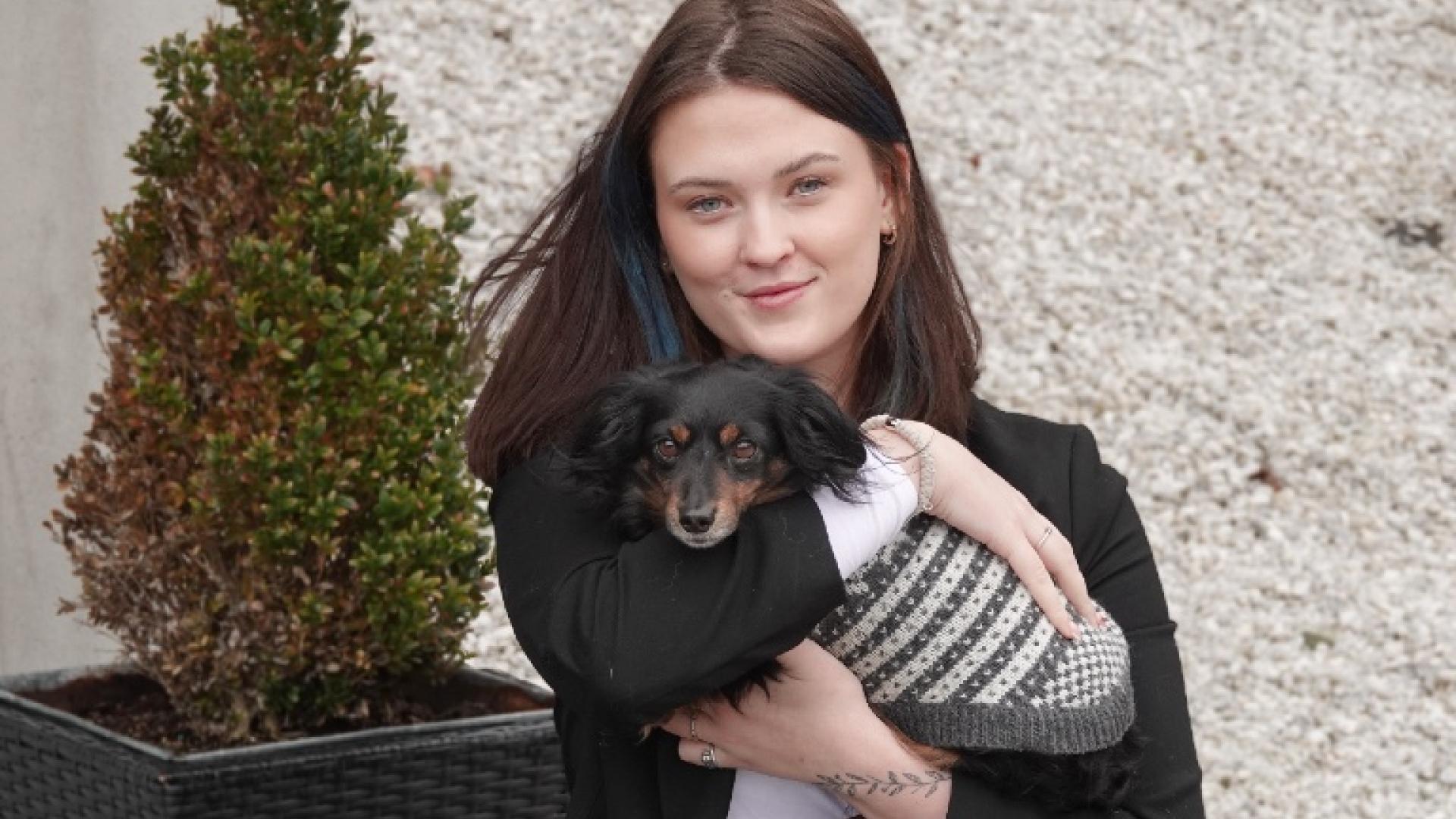 Jente som holder sin hund 