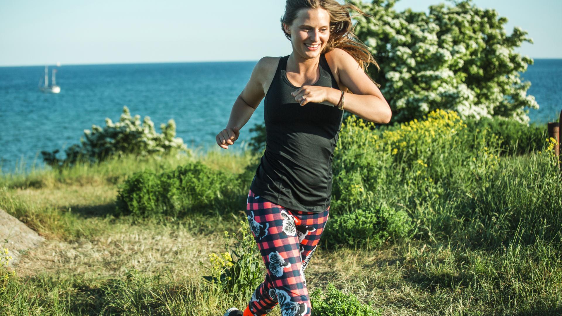 Dame som jogger ute i naturen med Behandling enkel fra Tryg